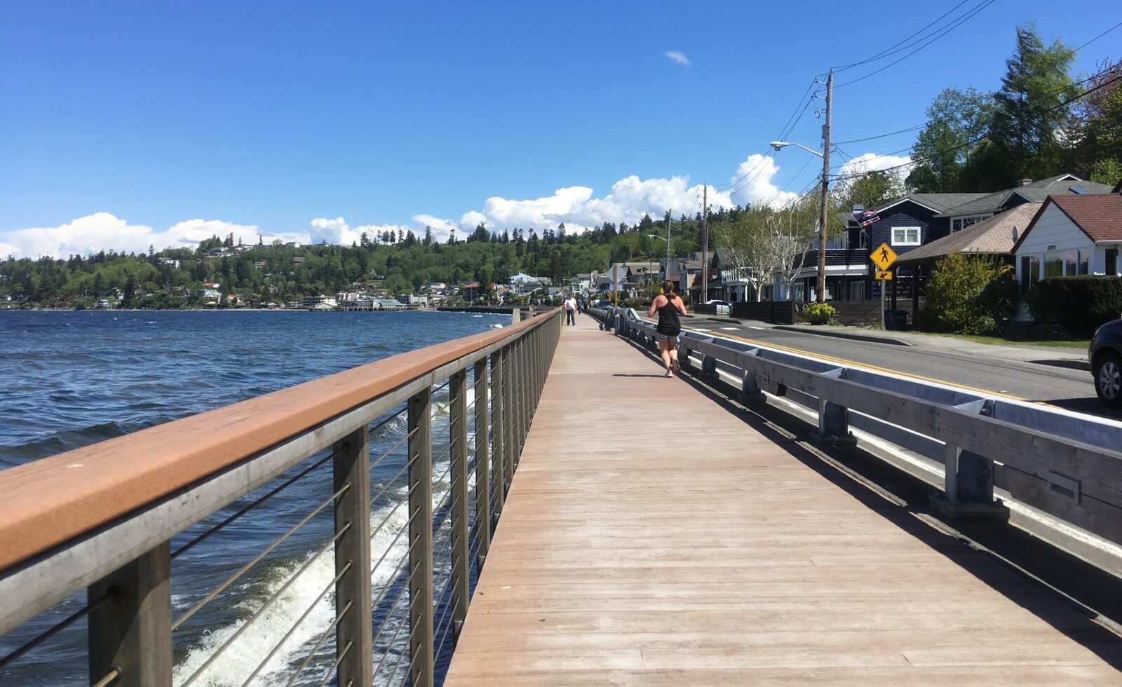 Person jogging along a waterfront boardwalk, representing health and recreational vehicle coverage